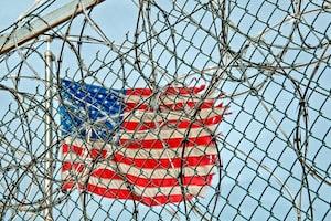 US flag through a fence