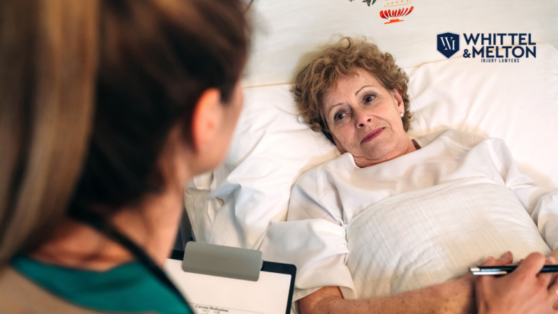 Nurse or caregiver sitting beside an elderly female patient in a nursing home bed, with the Whittel & Melton logo visible. Citrus County nursing home negligence and Florida ALF injury lawyer.