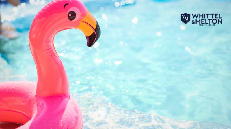 Bright pink inflatable flamingo float in a shimmering blue swimming pool, symbolizing Hernando County swimming pool drowning accidents, with the logo for Whittel & Melton Injury Lawyers.
